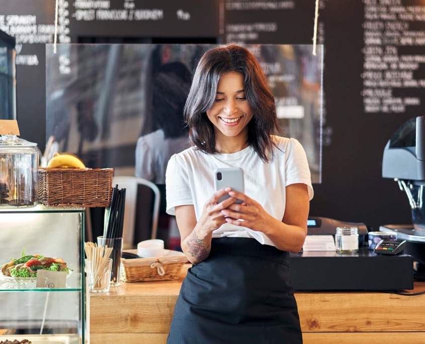Cafe Owner Using App in Shop